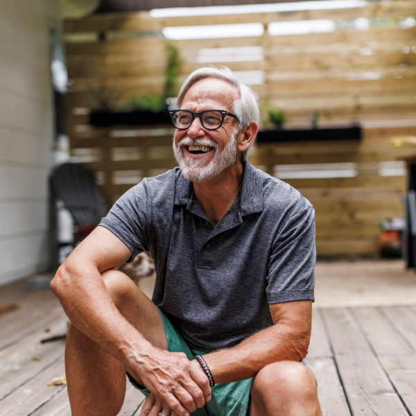 older man smiling on deck