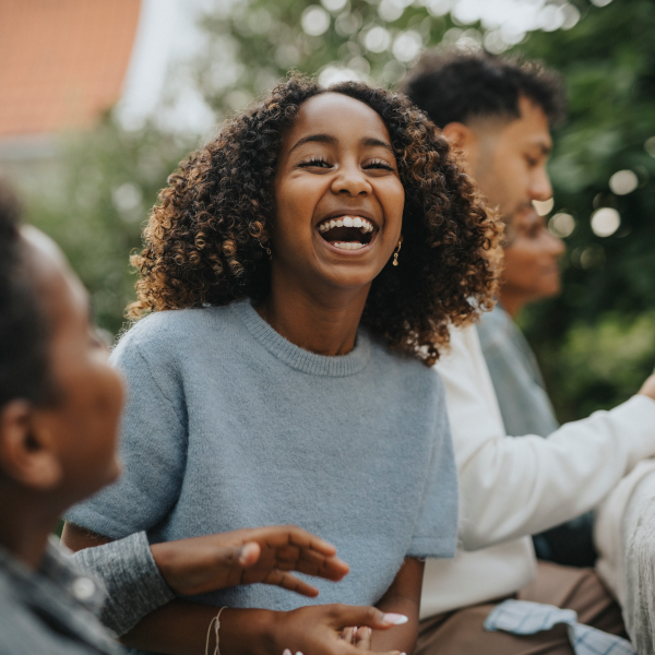 Teen girl laughing in group setting